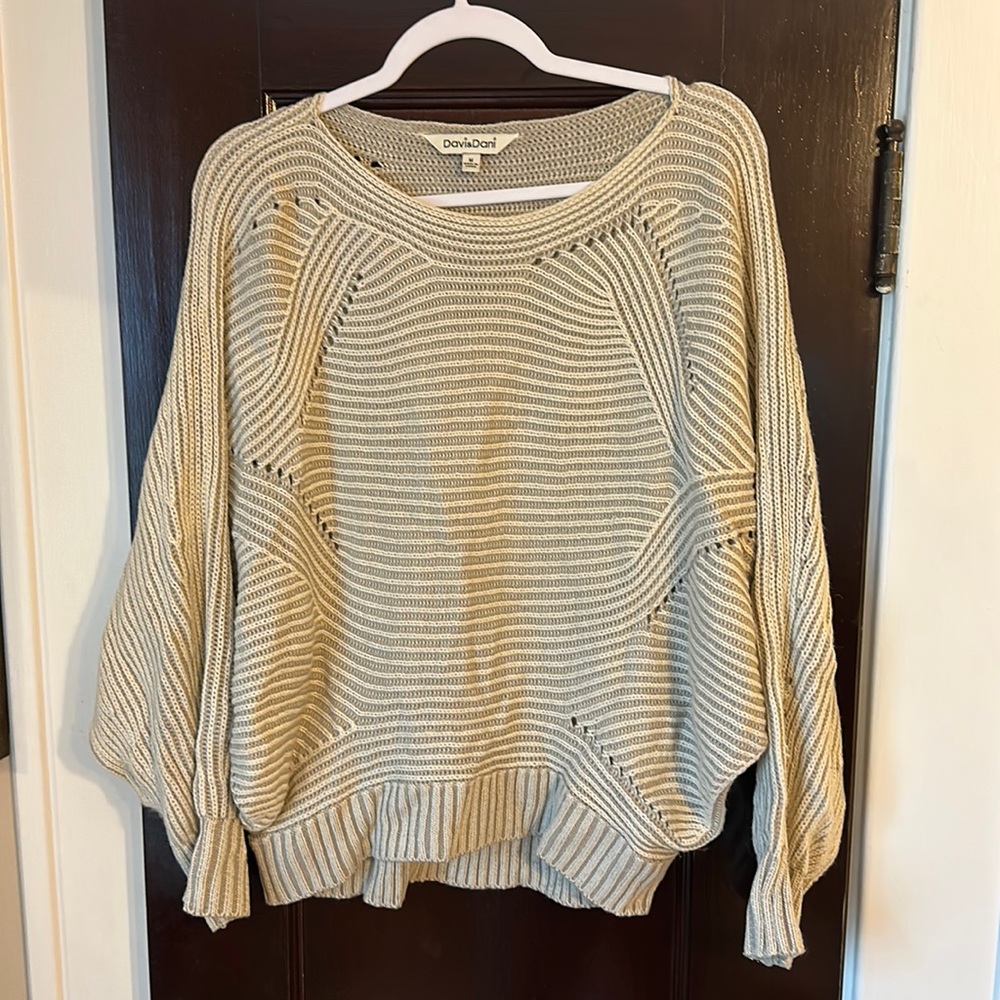 Woman’s beige sweater.